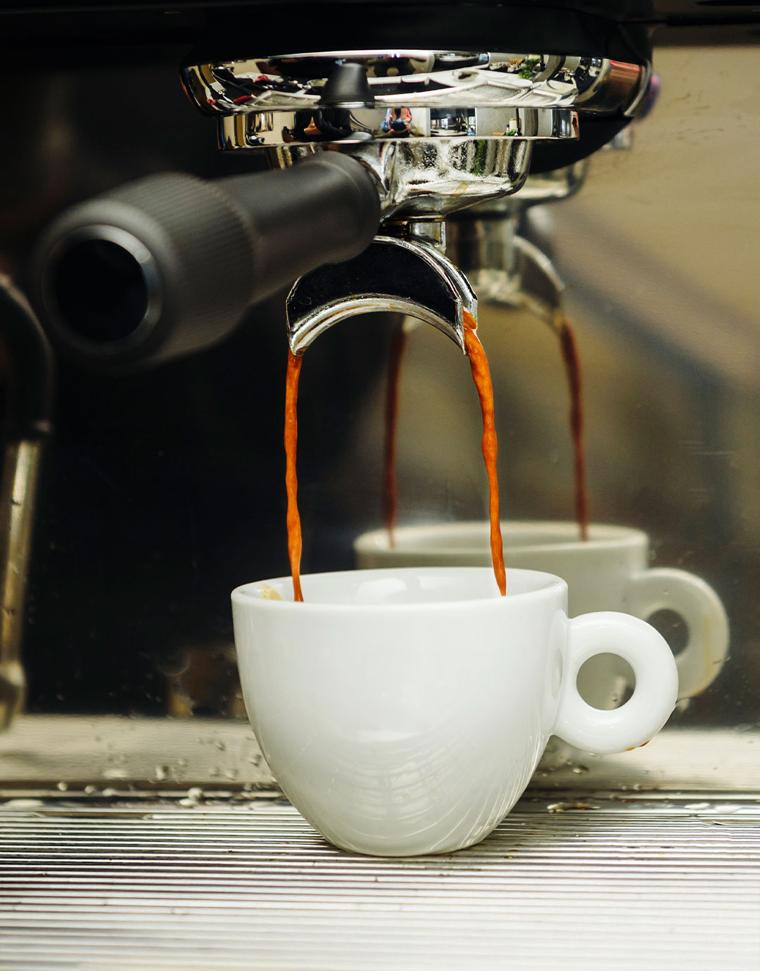 Espresso pouring into a white cup at Bread & Spread